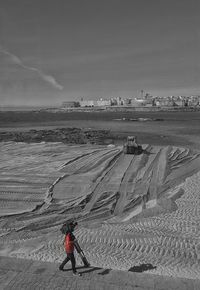 Man on beach against sky