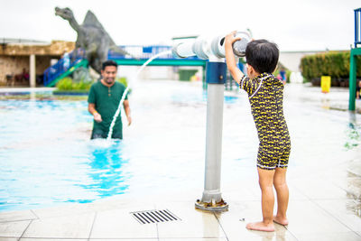 Full length of boys standing in swimming pool