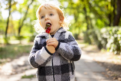 Portrait of young woman standing outdoors