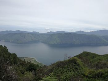 Scenic view of lake and mountains against sky