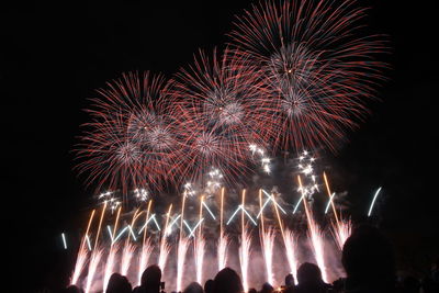 Low angle view of firework display at night