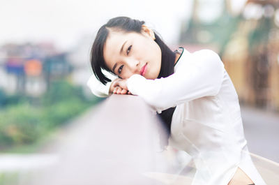 Portrait of young woman standing outdoors