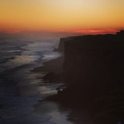 Scenic view of sea against dramatic sky