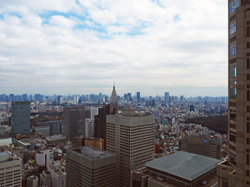 Skyscrapers against cloudy sky