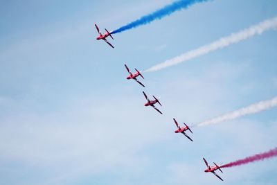 Low angle view of airshow against sky