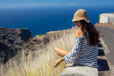 Rear view of woman sitting outdoors