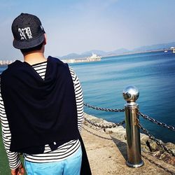 Rear view of man looking at sea