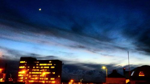 Low angle view of illuminated building against sky at dusk