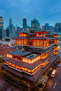 High angle view of buildings in city at dusk