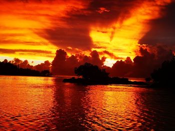 Scenic view of sea against dramatic sky during sunset