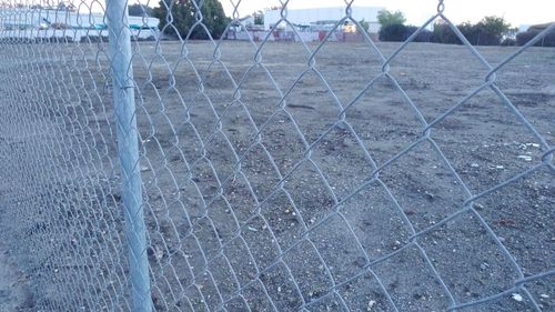 Close-up of fence against sky