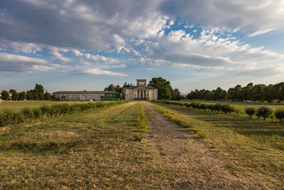 Building on field against sky