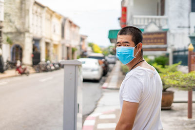 Portrait of man standing on street