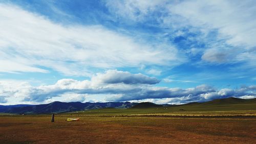 Scenic view of landscape against cloudy sky