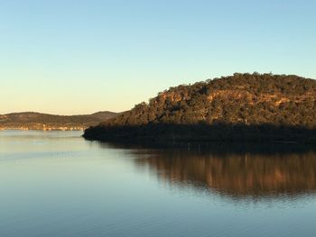 Scenic view of lake against clear blue sky