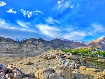 Scenic view of mountains against blue sky