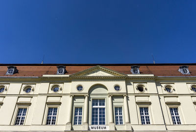 Low angle view of building against blue sky