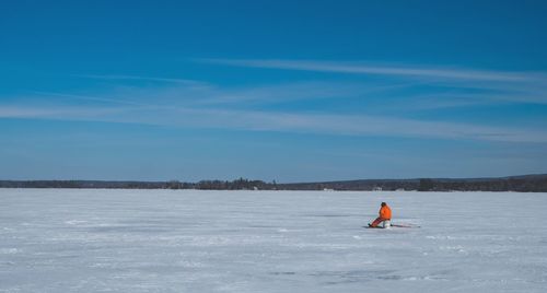 Man surfing on frozen lake against sky