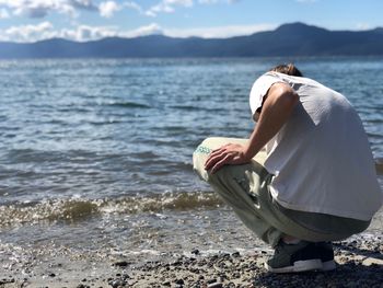 Rear view of woman standing on beach