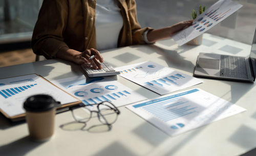 Midsection of businesswoman working at office