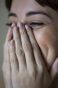 Close-up of young woman covering mouth