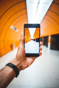 Midsection of man using mobile phone