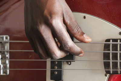 Close-up of man playing guitar