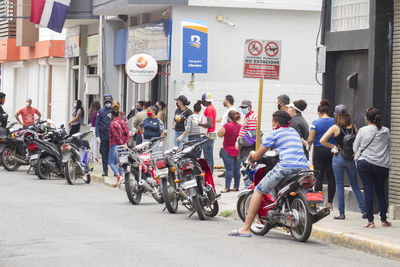 People riding bicycles on street in city