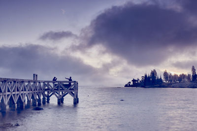 Pier over sea against sky