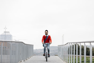 Casual businessman commuting in the city, using his folding bike