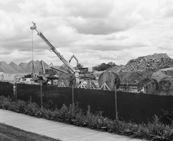 Construction site against cloudy sky