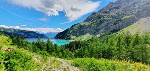 Scenic view of lake and mountains against sky