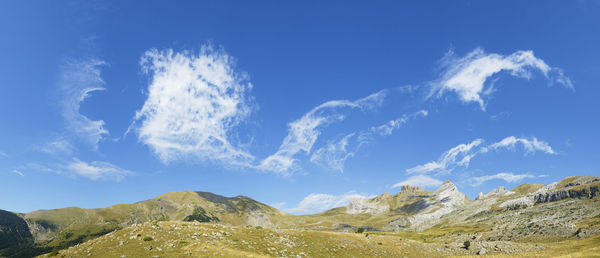 Low angle view of mountain against blue sky