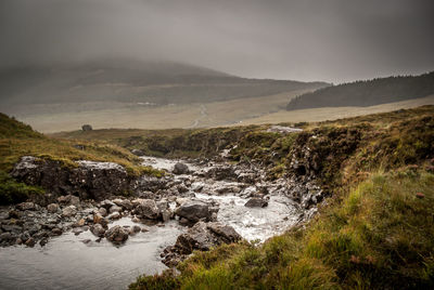 Scenic view of river flowing through rocks