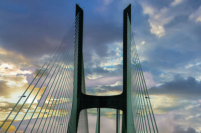 Low angle view of suspension bridge against sky