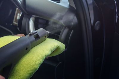 Cropped hand of man driving car