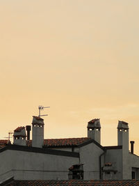 Buildings in city against sky during sunset