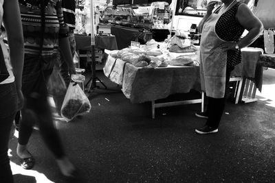 Low section of woman standing in market