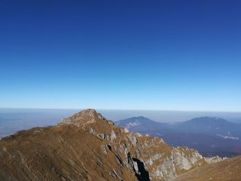 Scenic view of mountains against clear blue sky