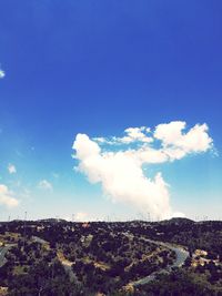 Scenic view of dramatic landscape against blue sky