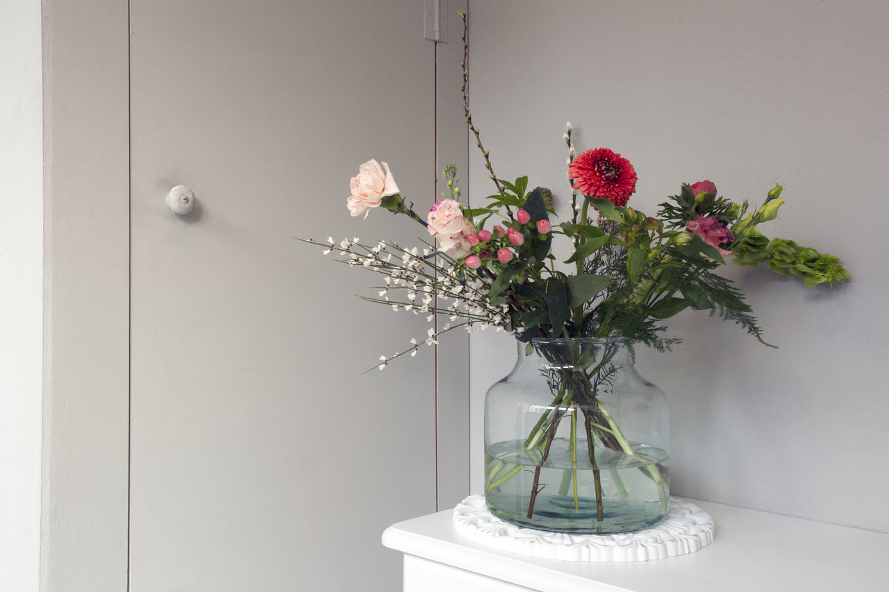 FLOWER VASE AGAINST WALL AT HOME