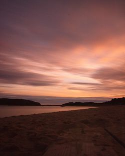 Scenic view of beach against dramatic sky