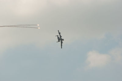 Low angle view of airplane flying in sky