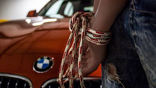 Midsection of man holding rope