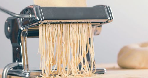 Homemade italian pasta with machine in the kitchen