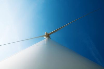 Low angle view of windmill against clear blue sky