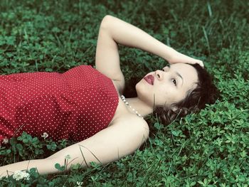 Portrait of woman lying on field