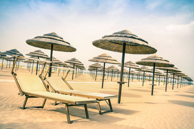 Umbrellas on beach against sky