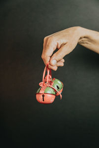 Cropped hand of man holding christmas ornament