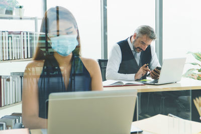 People working on table in office